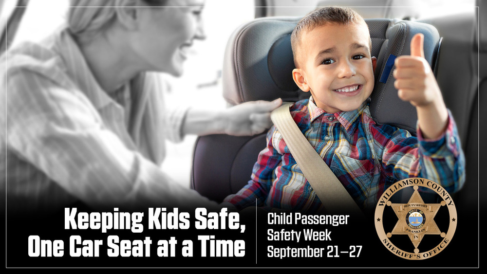 Child in Safety Seat giving thumbs up